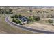 Scenic aerial shot of the home surrounded by mature trees and open fields in a quiet, upscale neighborhood at 9563 Red Primrose St, Franktown, CO 80116