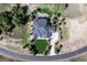 Aerial view of the home showcasing the manicured lawn and mature trees surrounding the property in a verdant setting at 9563 Red Primrose St, Franktown, CO 80116
