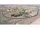 Aerial view of the house showing the property boundaries, surrounding landscape, and circular driveway on a sunny day at 9563 Red Primrose St, Franktown, CO 80116