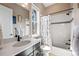 Bright bathroom featuring a modern vanity, marble countertops, and a shower-tub combination with stylish curtain at 9563 Red Primrose St, Franktown, CO 80116