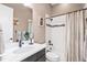 Stylish bathroom with white marble countertop, dark vanity, and tub shower with modern fixtures at 9563 Red Primrose St, Franktown, CO 80116