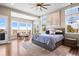Bright bedroom featuring many windows, a ceiling fan, a chandelier and lovely views at 9563 Red Primrose St, Franktown, CO 80116