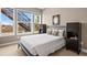 Bedroom featuring modern decor, bed and large windows with outside views at 9563 Red Primrose St, Franktown, CO 80116
