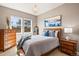 Comfortable bedroom with a chandelier, wooden furniture, and bright windows at 9563 Red Primrose St, Franktown, CO 80116