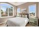 Cozy bedroom with three large windows, providing ample natural light and scenic views at 9563 Red Primrose St, Franktown, CO 80116