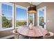 Cozy breakfast nook with large windows, a round table and comfortable seating at 9563 Red Primrose St, Franktown, CO 80116
