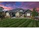 Stunning exterior showcasing a home with stone accents and a well-manicured lawn at 9563 Red Primrose St, Franktown, CO 80116
