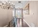 Elegant foyer featuring a modern chandelier, hardwood floors, and a view of the front door at 9563 Red Primrose St, Franktown, CO 80116