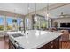 Spacious kitchen island featuring a sink, faucet and an open view into the living room at 9563 Red Primrose St, Franktown, CO 80116