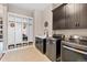 Well-equipped laundry room with modern washer, dryer, mud room storage, and sink at 9563 Red Primrose St, Franktown, CO 80116