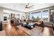 Open-concept living room features hardwood floors, comfortable seating and a large picture window at 9563 Red Primrose St, Franktown, CO 80116