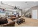 Comfortable living room featuring leather sectional sofa, projector and stairs to second floor at 9563 Red Primrose St, Franktown, CO 80116