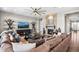 Cozy living room featuring a stone fireplace, plush seating, and stylish shelving, creating a warm and inviting atmosphere at 9563 Red Primrose St, Franktown, CO 80116