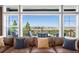 Comfortable living room with expansive windows showcasing scenic views and a plush sofa at 9563 Red Primrose St, Franktown, CO 80116