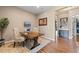 Bright home office featuring a live edge wood desk, TV, and direct access to a walk-in closet at 9563 Red Primrose St, Franktown, CO 80116