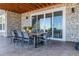 Covered patio with stone accents and an outdoor dining area at 9563 Red Primrose St, Franktown, CO 80116
