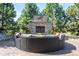 Outdoor seating area features a stone fireplace and comfortable wicker furniture at 9563 Red Primrose St, Franktown, CO 80116