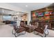 Sitting area featuring four chairs and wooden wall art for relaxing and conversation at 9563 Red Primrose St, Franktown, CO 80116