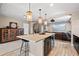 Basement wet bar featuring pendant lighting, island seating, and wine storage at 9563 Red Primrose St, Franktown, CO 80116