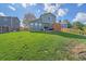 Large backyard with healthy lawn, patio area with grill, and wooden perimeter fence at 8414 Coralberry Ct, Parker, CO 80134
