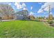 Spacious backyard with lush green grass, a patio area, and a wooden fence at 8414 Coralberry Ct, Parker, CO 80134
