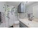 This full bathroom features a shower with a floral curtain and a stylish vanity sink at 8414 Coralberry Ct, Parker, CO 80134