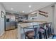 Well-lit kitchen with stainless steel appliances, granite countertops, and island with bar stool seating at 8414 Coralberry Ct, Parker, CO 80134
