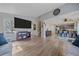 Bright and open living space with hardwood floors, large TV, and a view into the kitchen area at 8414 Coralberry Ct, Parker, CO 80134