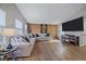 Cozy living room featuring a sectional sofa, modern décor, and an entertainment center at 8414 Coralberry Ct, Parker, CO 80134