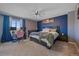 Comfortable primary bedroom featuring a king bed, a large window, and stylish décor at 8414 Coralberry Ct, Parker, CO 80134