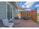 Outdoor patio featuring brick floors, shade sails, privacy fence, and a dining set at 8414 Coralberry Ct, Parker, CO 80134