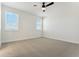 Well-lit bedroom with neutral carpeting and ceiling fan at 42976 Colonial Trl, Elizabeth, CO 80107