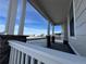 Covered porch with white railing and stone accents at 42976 Colonial Trl, Elizabeth, CO 80107