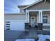 Modern home exterior with covered porch and attached garage at 42976 Colonial Trl, Elizabeth, CO 80107