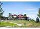 Expansive golf course and clubhouse with manicured greens under a clear blue sky at 42976 Colonial Trl, Elizabeth, CO 80107