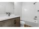 Charming bathroom features a wood vanity, stylish fixtures, a shower-tub combination with white tile, and plank flooring at 761 Muturu Rd, Johnstown, CO 80542
