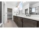Modern bathroom features double sinks, a walk in closet, stylish fixtures, and neutral tile flooring creating a spa-like retreat at 761 Muturu Rd, Johnstown, CO 80542