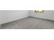 Bright bedroom features a large window providing natural light, complemented by neutral wall paint and plush gray carpet at 761 Muturu Rd, Johnstown, CO 80542