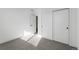 A bedroom with light gray carpet, minimalist decor, and a double-door closet at 761 Muturu Rd, Johnstown, CO 80542
