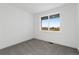 Minimalist bedroom design with gray carpet and a scenic outdoor view from the large picture window at 761 Muturu Rd, Johnstown, CO 80542