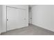 Bright bedroom features a closet with sliding doors, neutral paint, and plush gray carpet providing a cozy and inviting space at 761 Muturu Rd, Johnstown, CO 80542