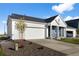 Lovely home featuring a two-car garage, tidy landscaping and blue and white siding at 761 Muturu Rd, Johnstown, CO 80542