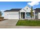 Charming home featuring a two-car garage, blue and white siding, a well-manicured lawn and a covered entryway at 761 Muturu Rd, Johnstown, CO 80542