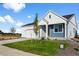 Beautiful home with well-kept lawn, tidy landscaping, and charming white and blue siding detail at 761 Muturu Rd, Johnstown, CO 80542