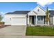 Beautifully designed home featuring a two-car garage, well-manicured lawn and blue and white siding at 761 Muturu Rd, Johnstown, CO 80542