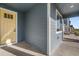 Home's porch with light yellow door, gray siding, and trimmed white accent at 761 Muturu Rd, Johnstown, CO 80542
