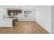 Modern kitchen features a center island, sleek flooring, and stainless appliances, creating a stylish and functional culinary space at 761 Muturu Rd, Johnstown, CO 80542