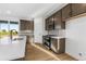 Updated kitchen showcasing stainless steel appliances, custom cabinetry, and a view through sliding glass doors at 761 Muturu Rd, Johnstown, CO 80542