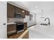 Well-appointed kitchen with stainless steel appliances, solid-surface countertops and modern cabinetry at 761 Muturu Rd, Johnstown, CO 80542