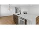 Modern kitchen showcasing stainless steel appliances and a central island sink under a stylish light fixture at 761 Muturu Rd, Johnstown, CO 80542